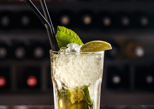 Mojito cocktail with lime and mint in highball glass